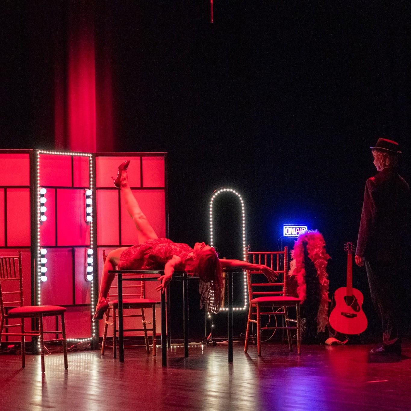 Performer on a table in an original Funky Business theatre production