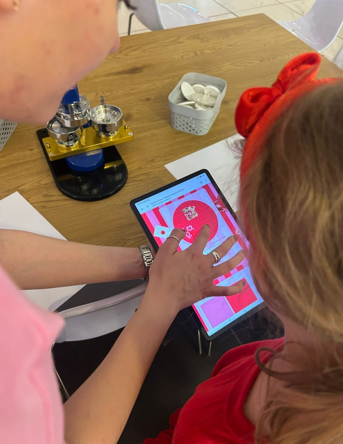 Participant personalising a badge on a tablet
