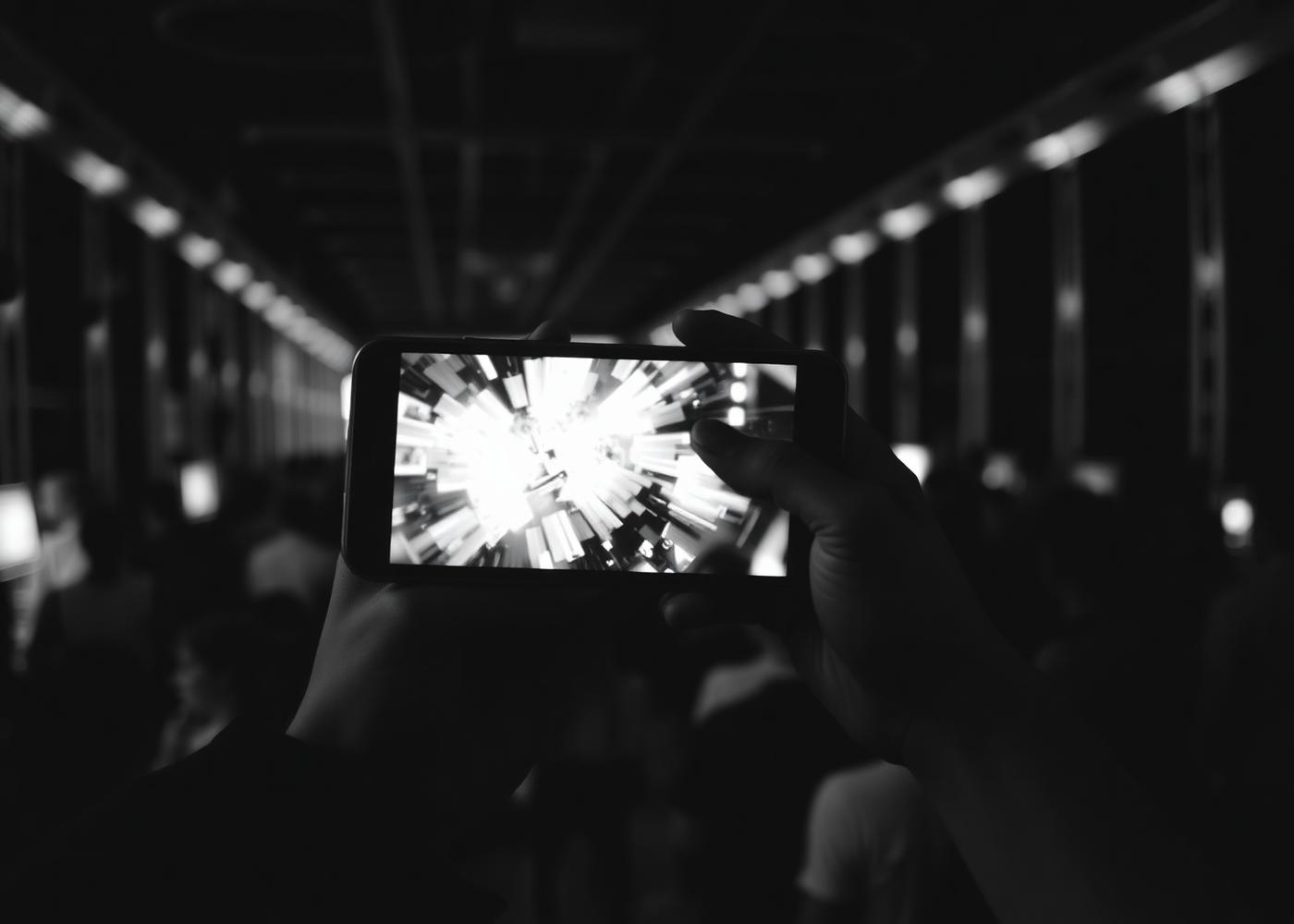 Visitor holding a phone showing an interactive experience