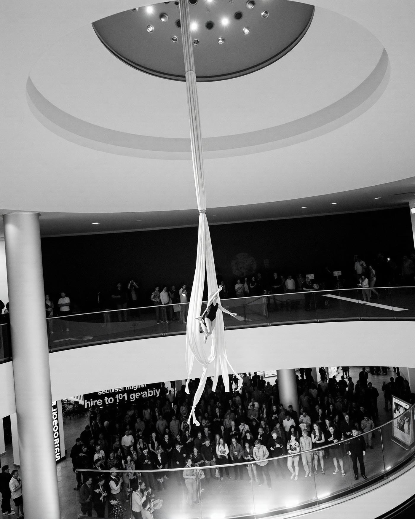 Aerial performer above a mall atrium during an opening